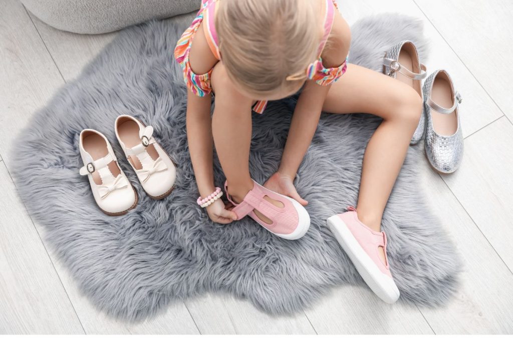 Child putting on their own shoes in Westfield, NJ at Christopher Academy Montessori School